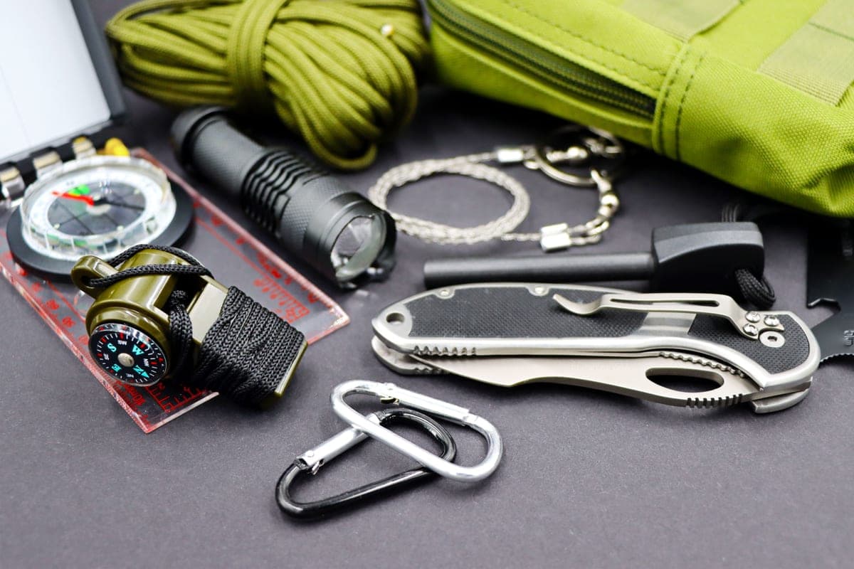 Small everyday carry items arranged on a dark surface