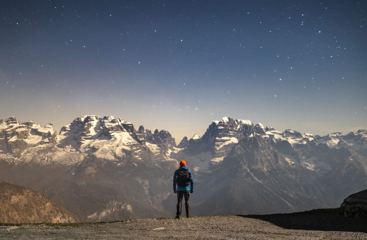 A backpacker crossing high ground at night