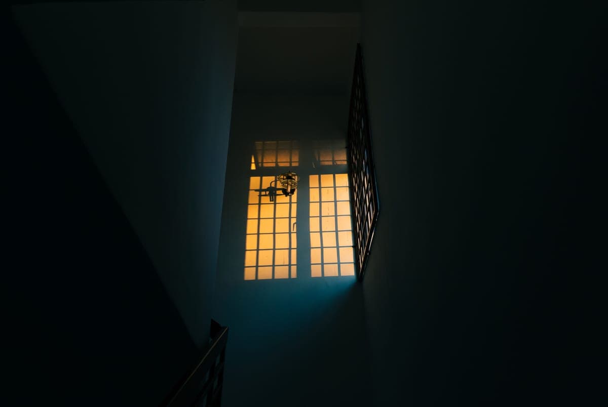 A dark hallway inside a house at night
