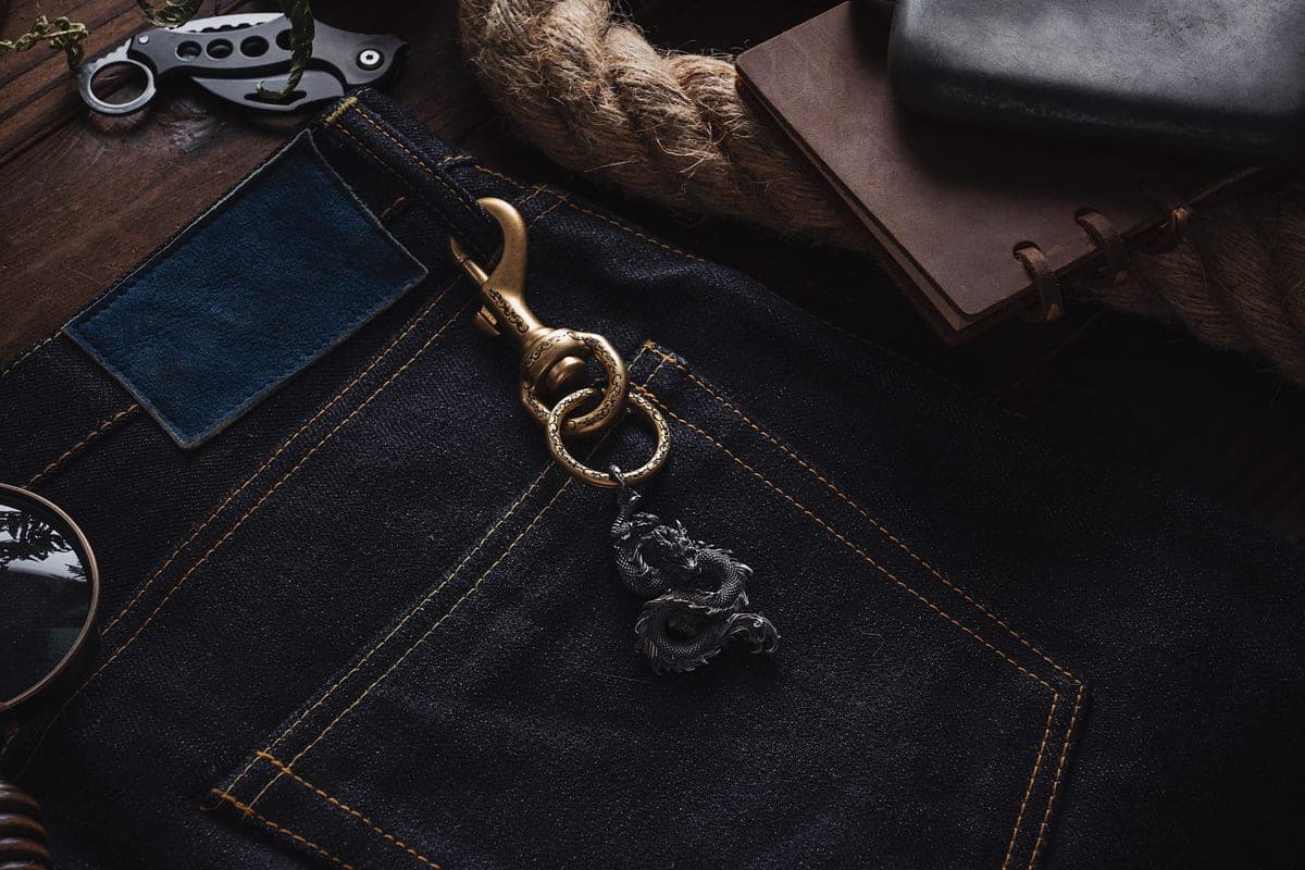 A pocket clip on the edge of a trouser pocket