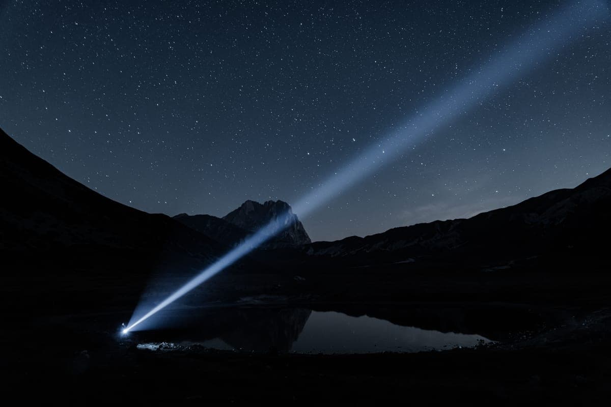 A long beam of light crossing a dark valley